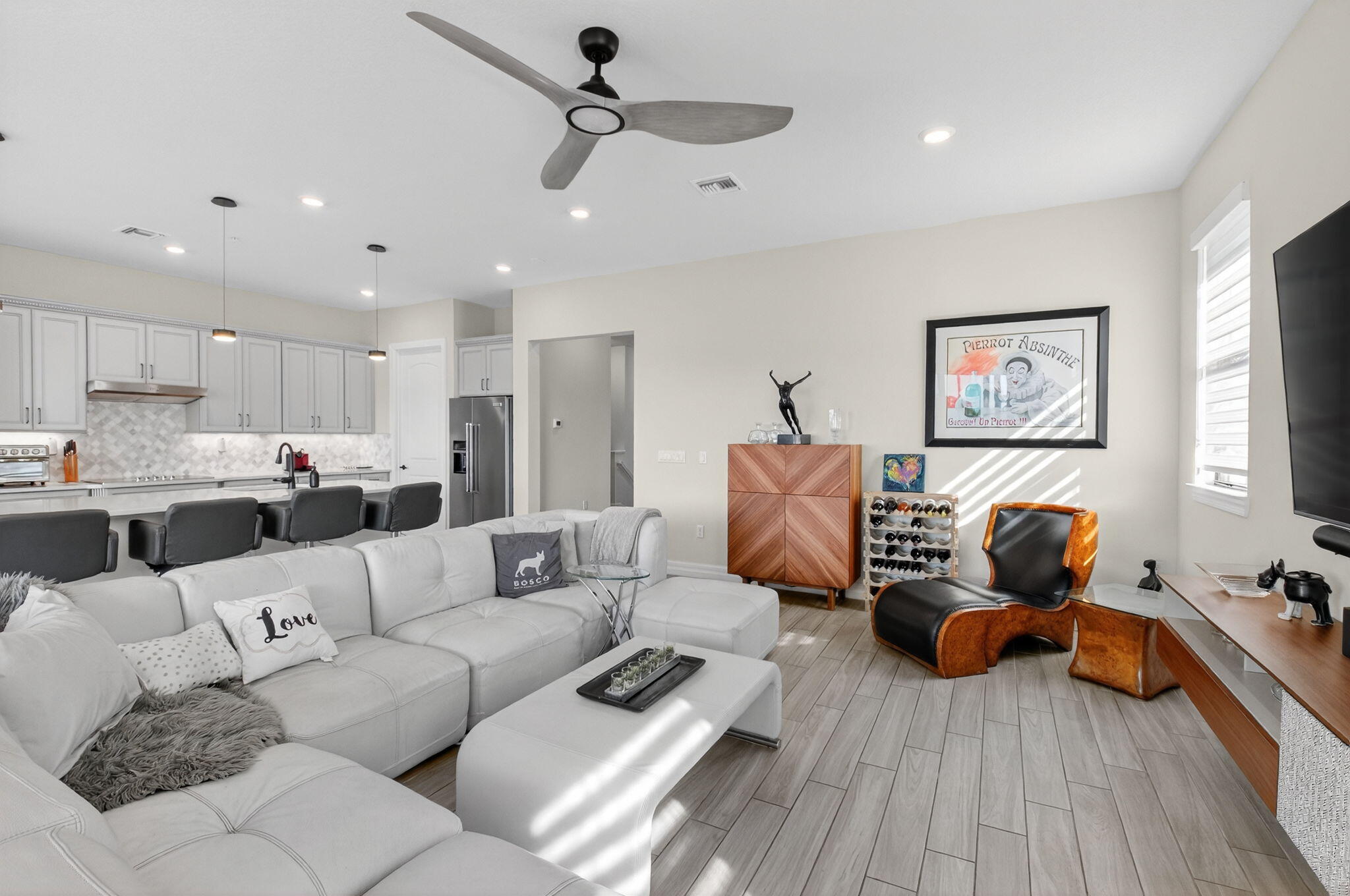 21956 Canadensis Circle, Unit 201 Boca Raton, FL 33428 - Photo 8 of 47 a living room with furniture kitchen view and a wooden floor