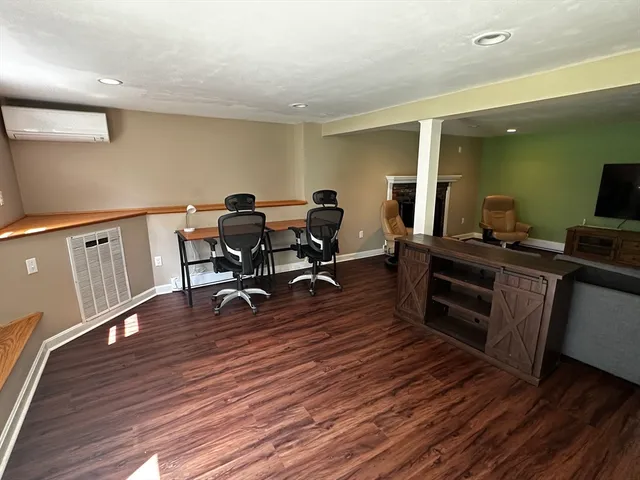 a view of a workspace with wooden floor