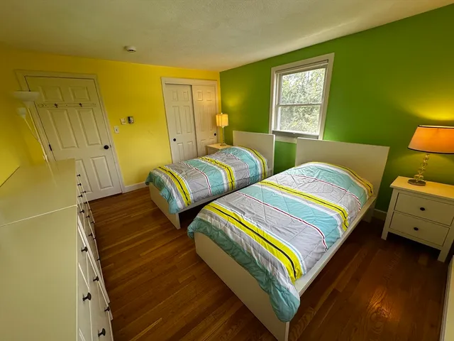 a bedroom with two beds and painted walls