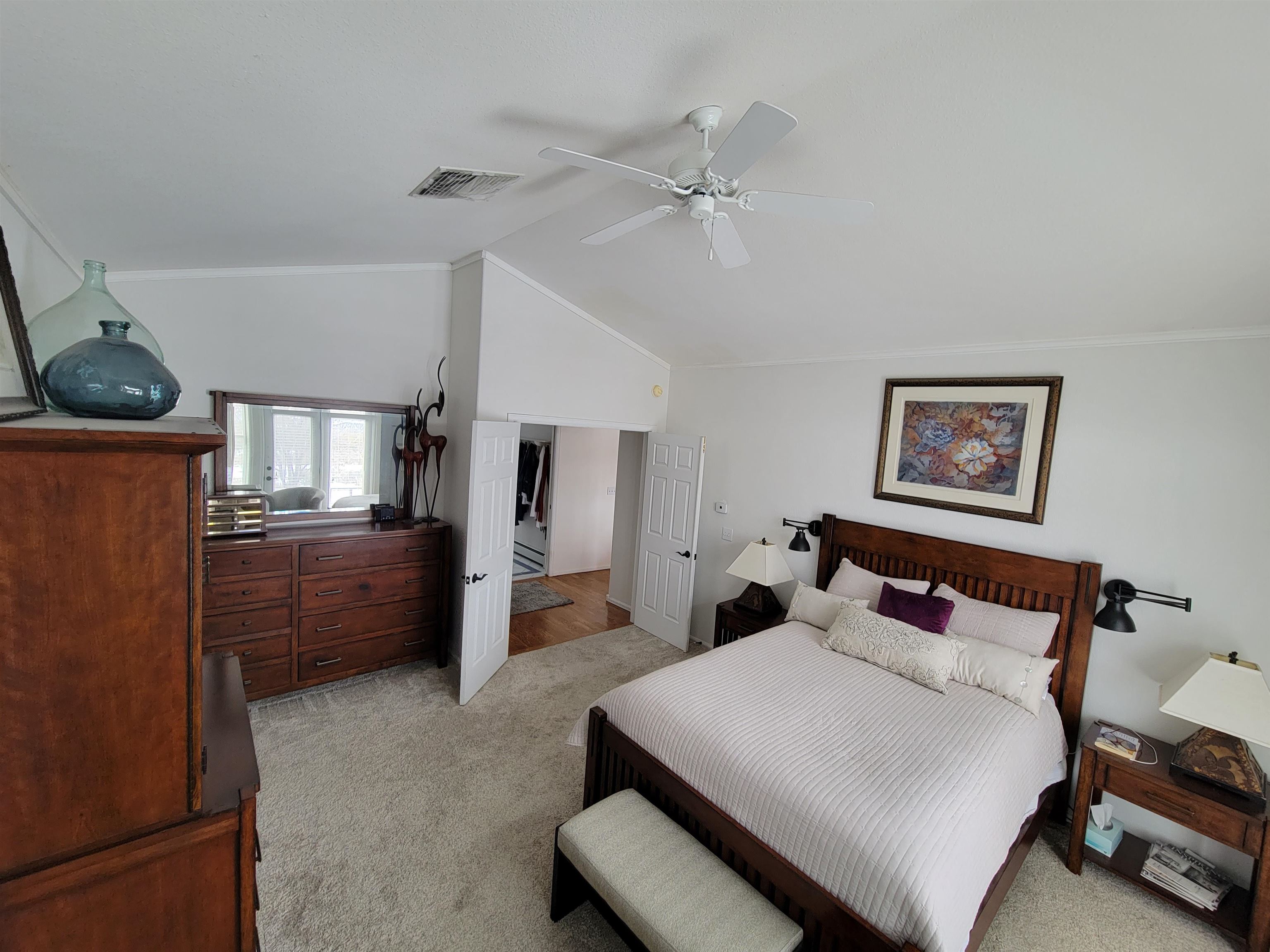 15753 Heavens View Road Cedaredge, CO 81413 - Photo 11 of 33 a bedroom with a bed and a chandelier