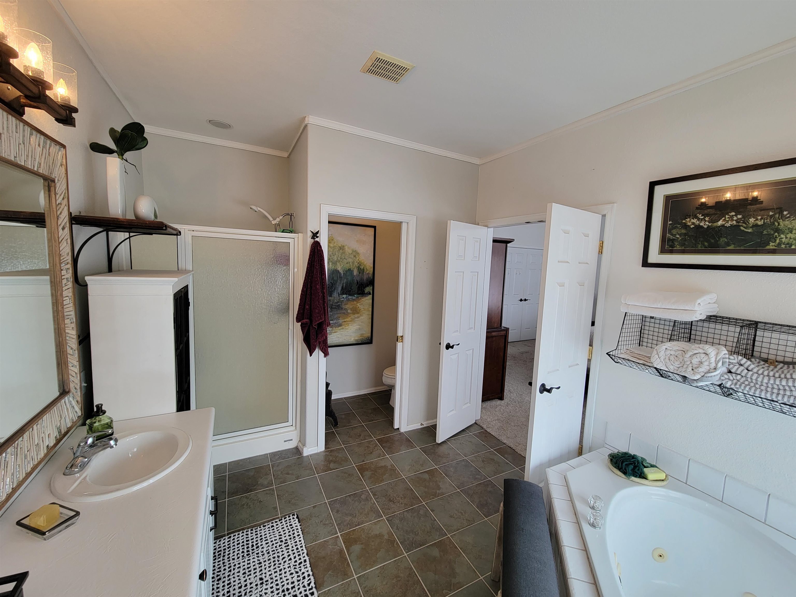 15753 Heavens View Road Cedaredge, CO 81413 - Photo 13 of 33 a bathroom with a tub sink and a mirror