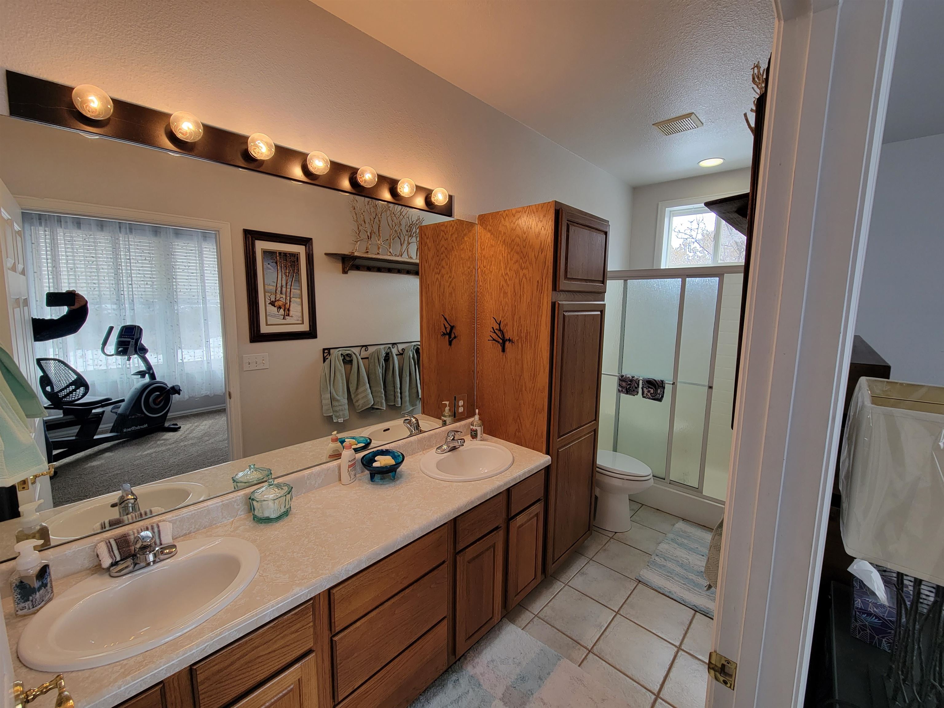 15753 Heavens View Road Cedaredge, CO 81413 - Photo 20 of 33 a bathroom with a sink double vanity and a mirror