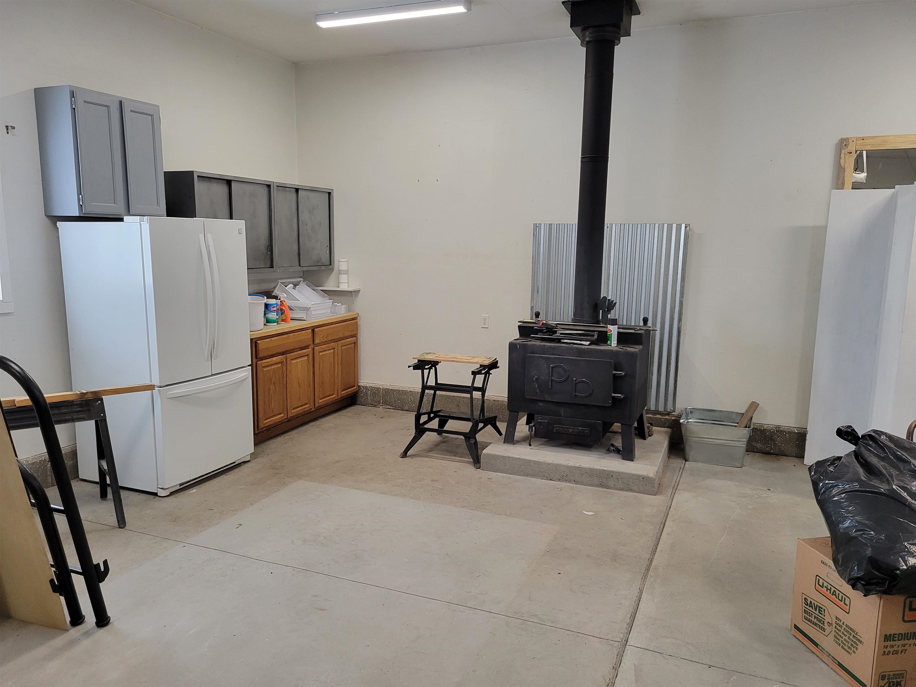 15753 Heavens View Road Cedaredge, CO 81413 - Photo 25 of 33 a room with furniture a washer and a refrigerator