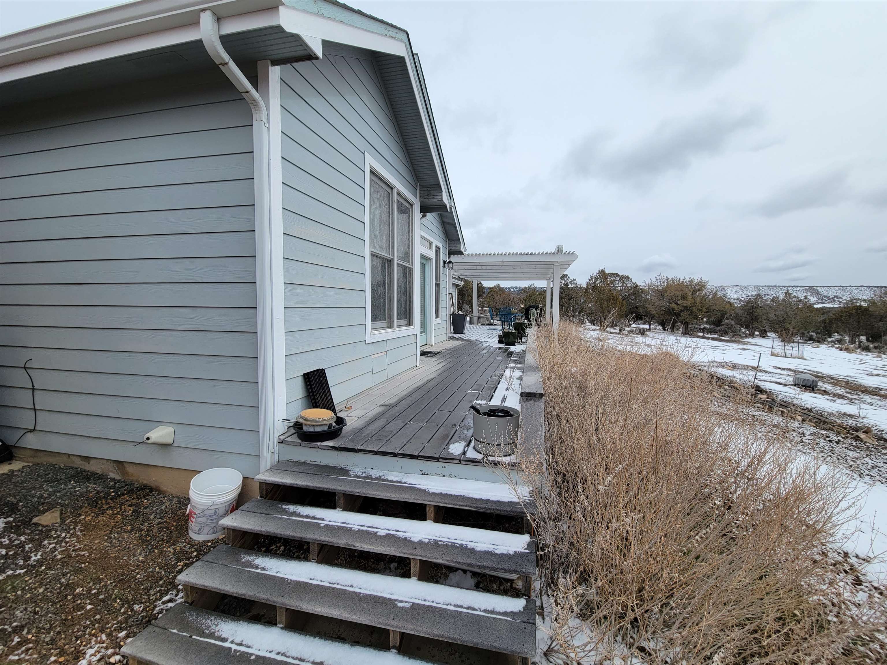 15753 Heavens View Road Cedaredge, CO 81413 - Photo 27 of 33 a view of a patio with a table and chairs and floor