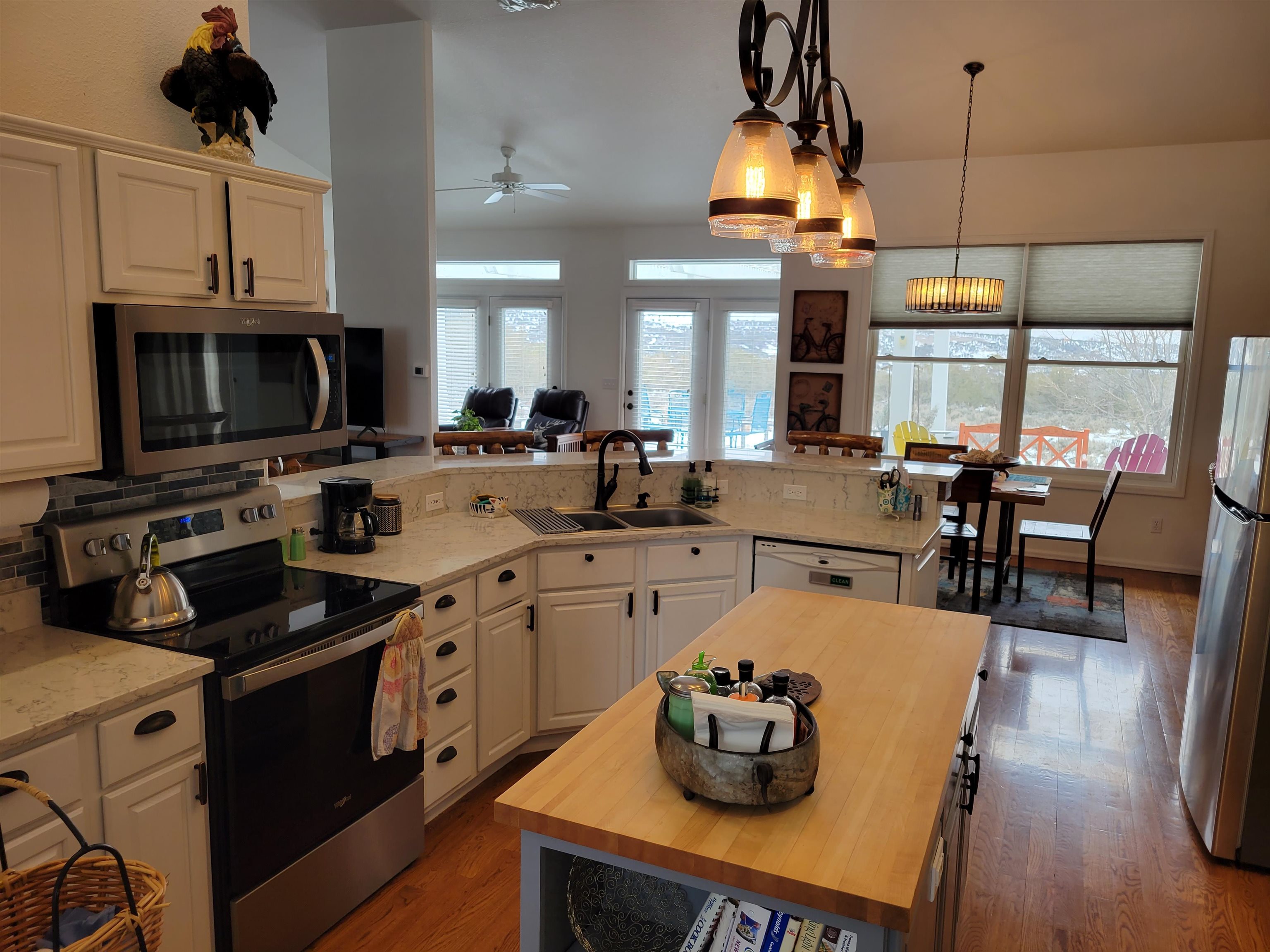 15753 Heavens View Road Cedaredge, CO 81413 - Photo 5 of 33 a open kitchen with stainless steel appliances granite countertop a stove a sink dishwasher a dining table and chairs with wooden floor