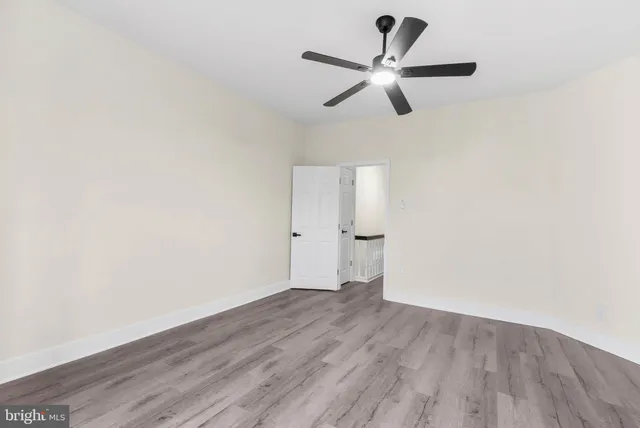 a view of a room with wooden floor and white walls