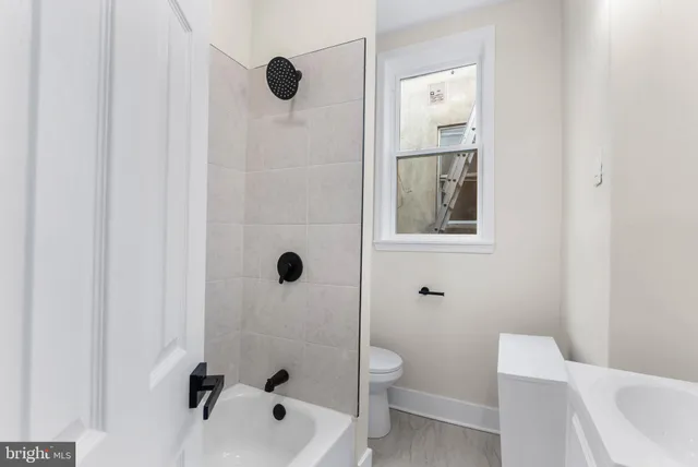 a bathroom with a toilet and shower