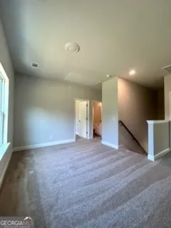 an empty room with a empty space and windows