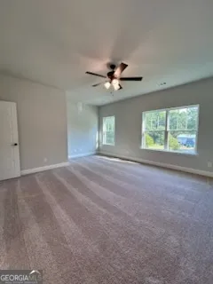 a view of a livingroom with a ceiling fan and window