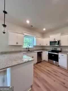 a kitchen with stainless steel appliances granite countertop a sink counter space and cabinets