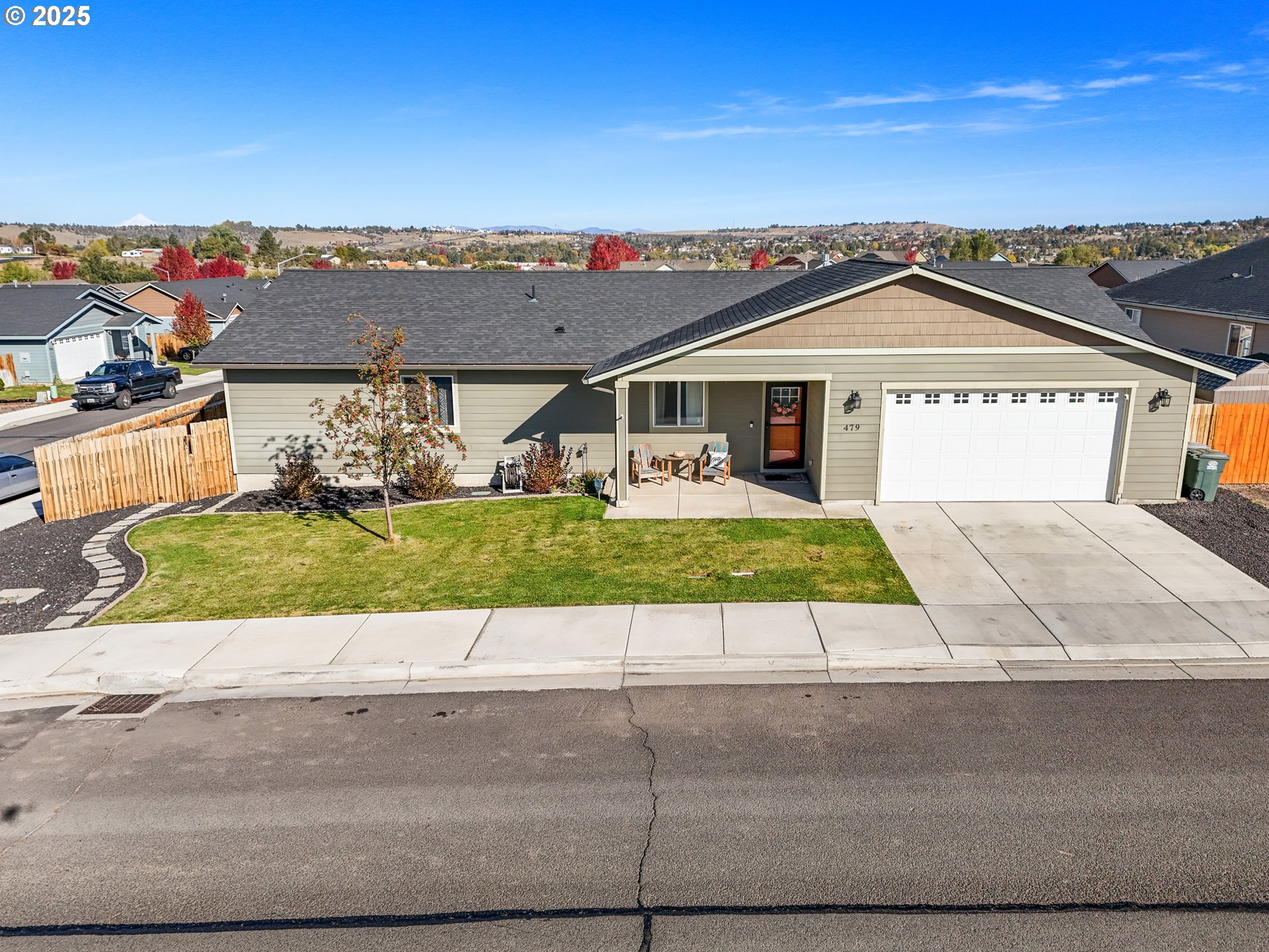a view of a house with a yard and potted plants