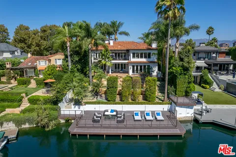 a view of house with garden space and sitting area