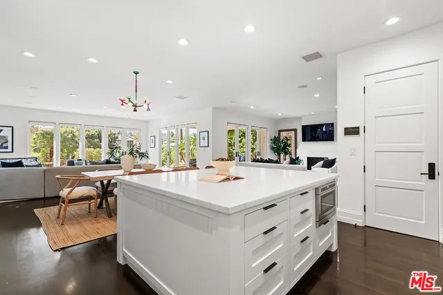 a living room with furniture and large windows