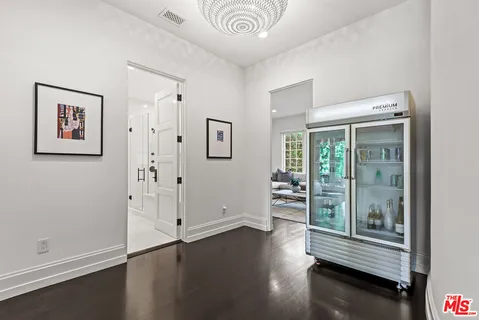 a living room with furniture a flat screen tv and a floor to ceiling window