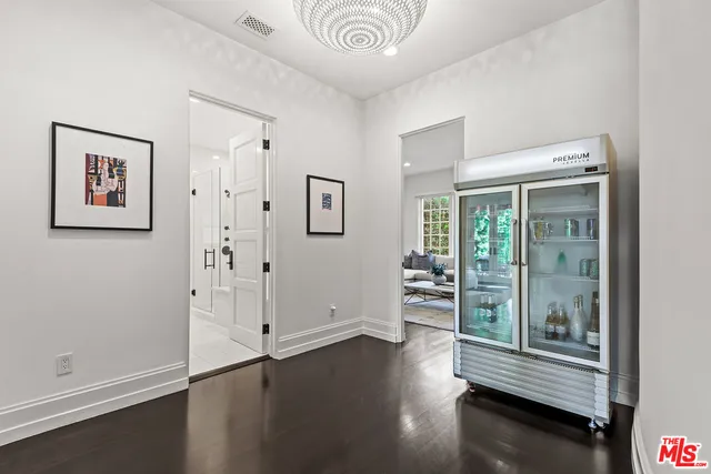a living room with furniture a flat screen tv and a floor to ceiling window