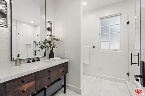 a bedroom with a bed and large windows