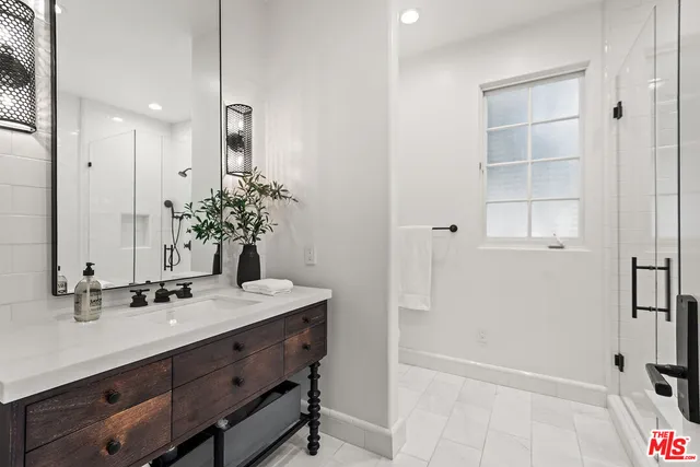 a bedroom with a bed and large windows