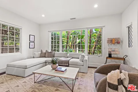 a spacious bedroom with a large bed and a large window