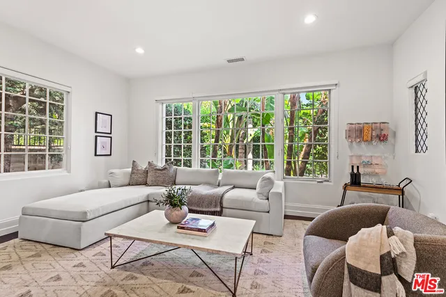 a spacious bedroom with a large bed and a large window