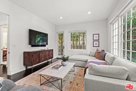 a view of a livingroom with furniture outdoor kitchen view and a bathroom