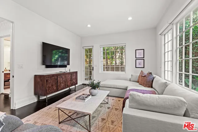 a view of a livingroom with furniture outdoor kitchen view and a bathroom