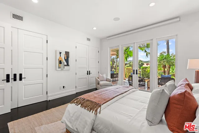a living room with furniture a table and a large window