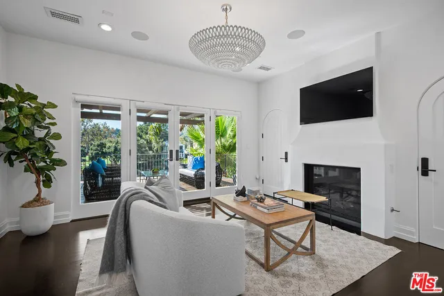 a spacious bedroom with a bed and a chandelier