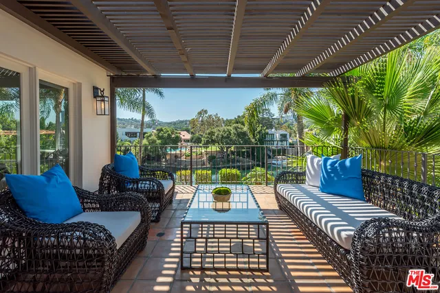 a bedroom with a bed and large window
