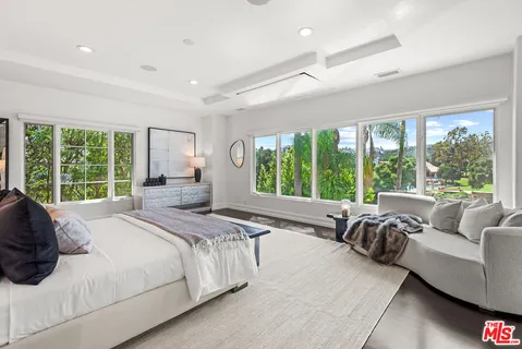 a white bath tub sitting next to a white sink