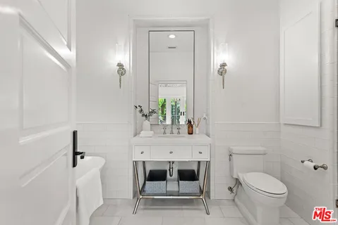 a utility room with dryer washer and a view of kitchen
