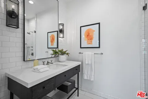 a view of a house with a yard and palm trees