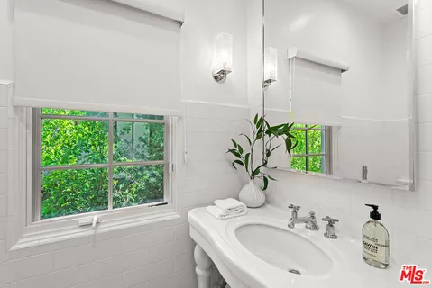 a picture of a bathroom with a sink and a mirror