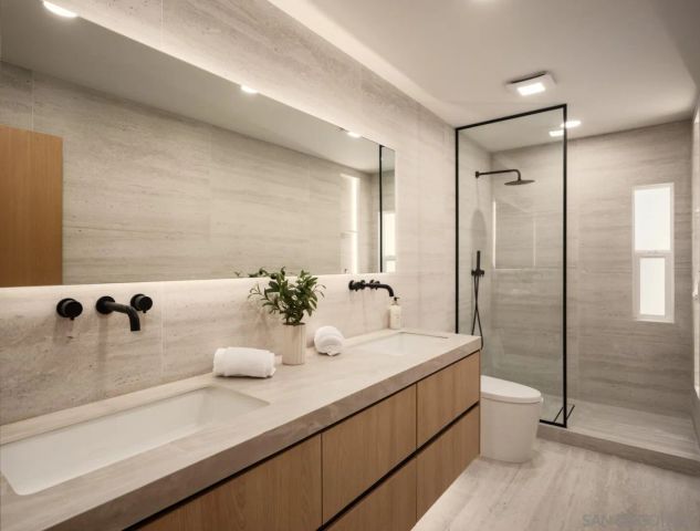 a bedroom with furniture and a large window