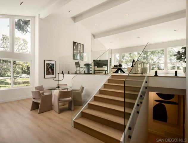 a living room with furniture and a floor to ceiling window