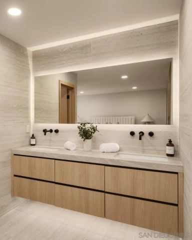 a bathroom with a double vanity sink mirror and shower