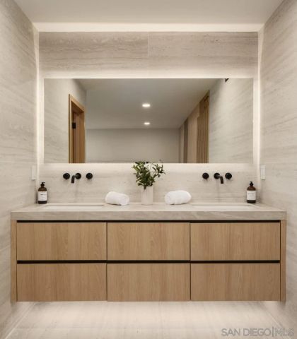 a bathroom with a sink vanity and mirror