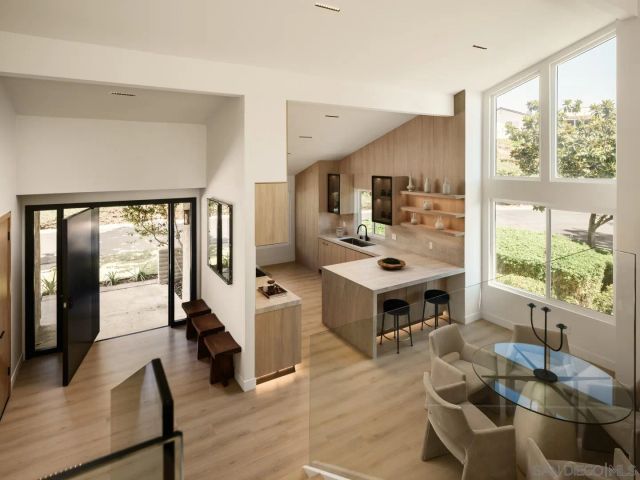 a living room with furniture large window and flat screen tv