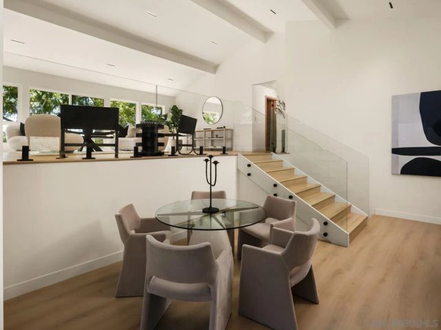 a dining room with furniture and wooden floor