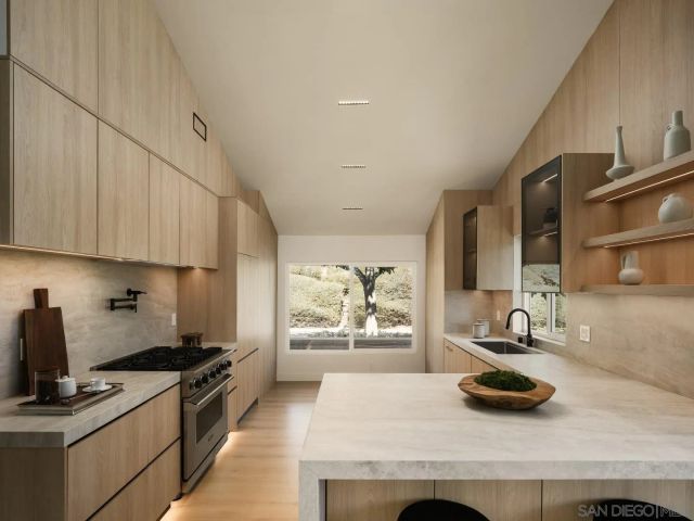 a kitchen with sink refrigerator and window