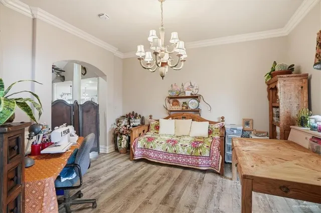 a living room with furniture a bookshelf and a window