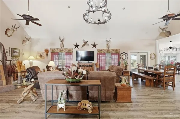 a living room with lots of furniture and a chandelier