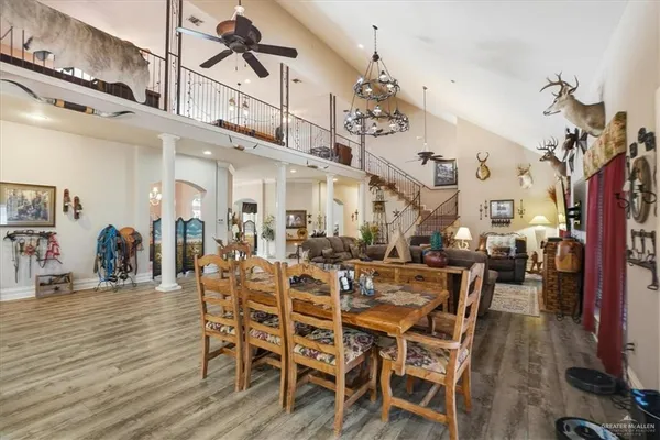 a kitchen with a table chairs refrigerator and cabinets