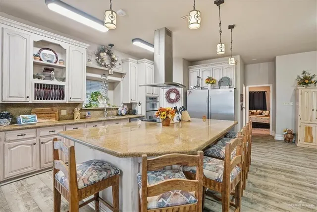 a kitchen with stainless steel appliances granite countertop a sink and a refrigerator