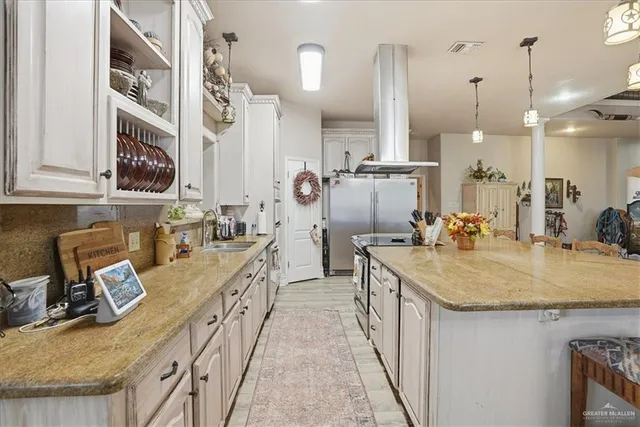 a large kitchen with stainless steel appliances granite countertop a lot of counter space and cabinets