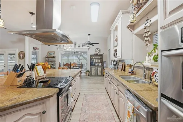 a living room with lots of furniture and view of kitchen