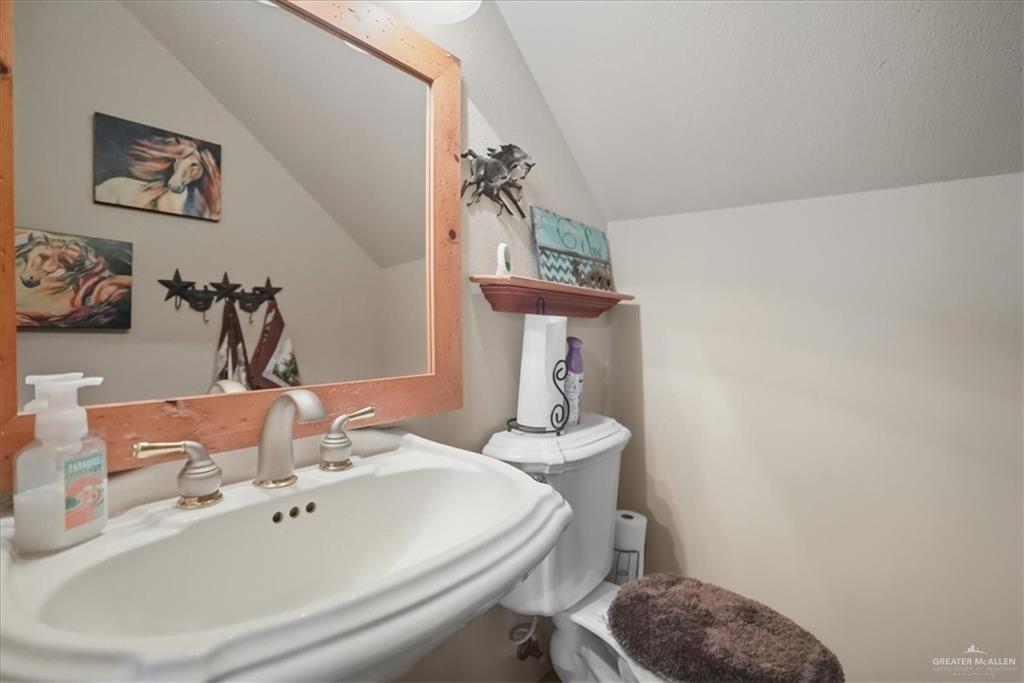 15561 Highway 281 Premont, TX 78375 - Photo 41 of 43 a bathroom with a sink a toilet and mirror