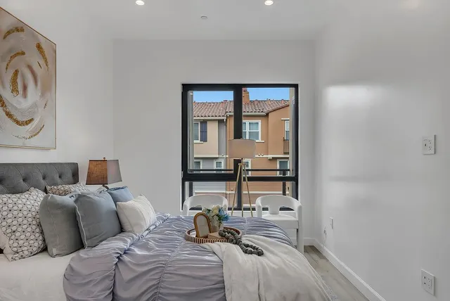 a bedroom with a bed and a window