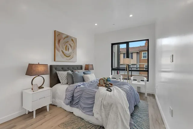 a bedroom with bed and window
