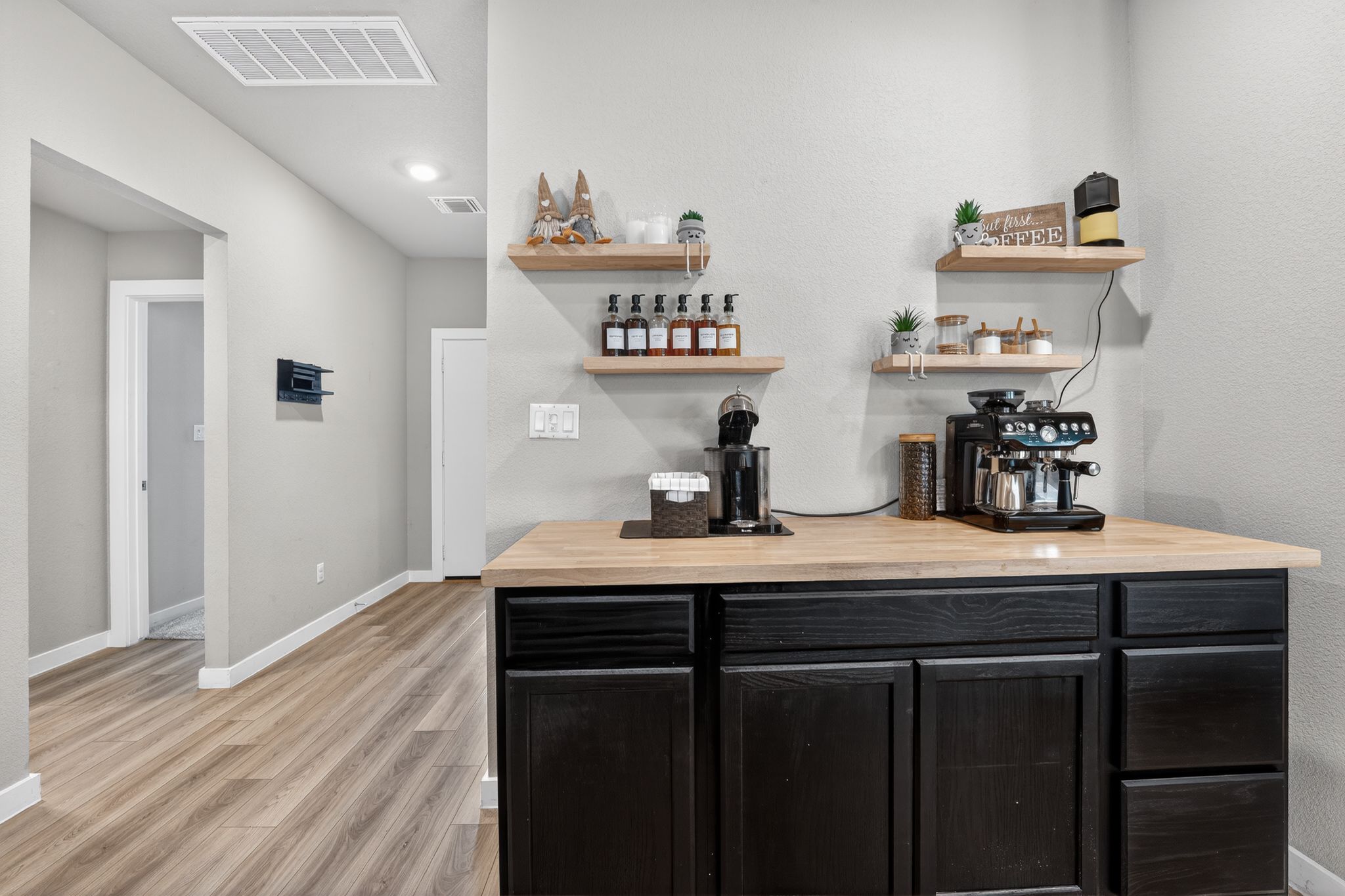 117 Halford Road Georgetown, TX 78633 - Photo 9 of 31 Indoor dry bar with wood counters, dark cabinets, light wood-style floors, and open shelves