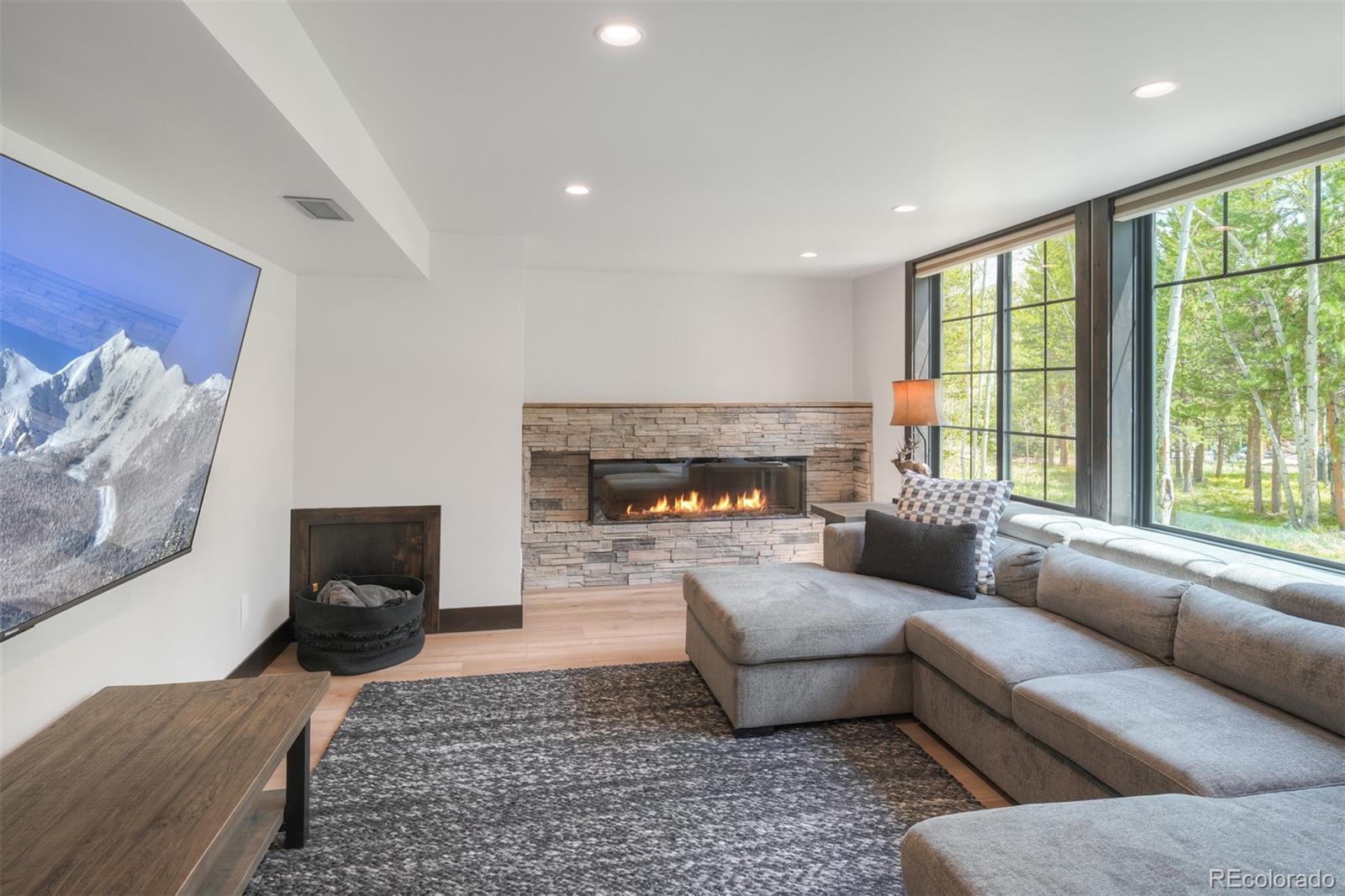 306 Golden Eagle Road Silverthorne, CO 80498 - Photo 27 of 43 a living room with furniture and a fireplace